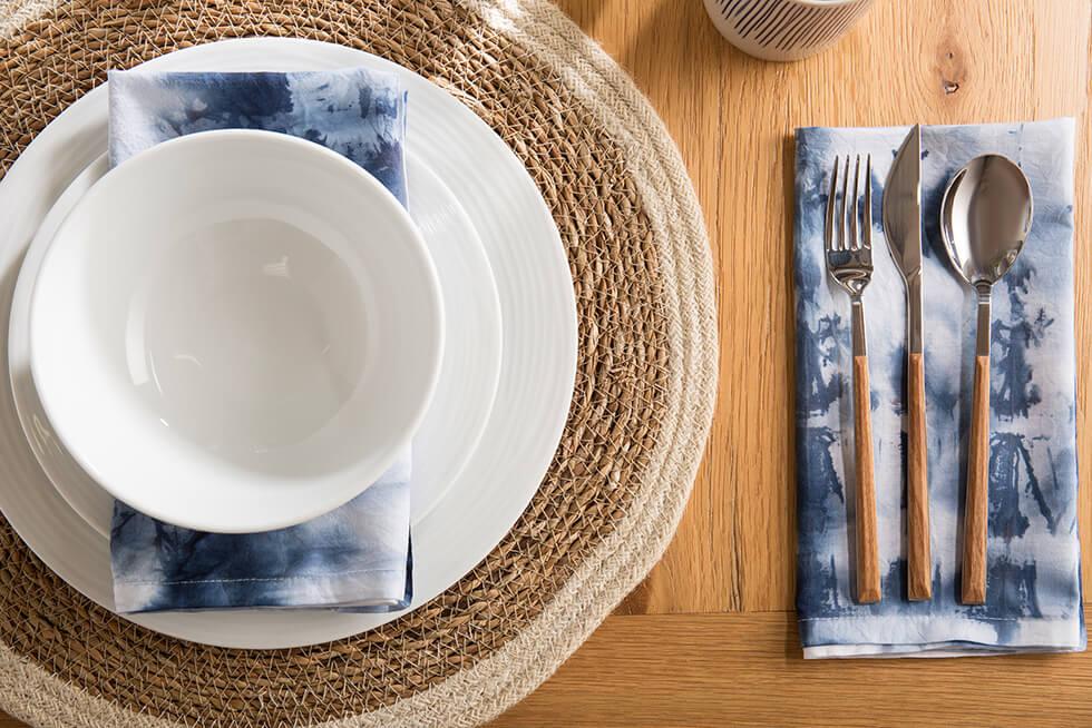 Navy blue shibori tie dye napkins on a wooden dining table