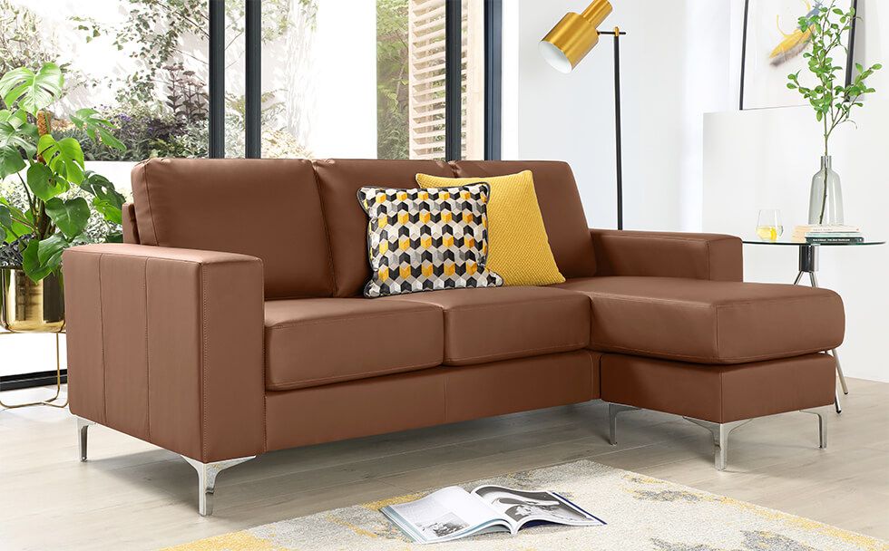 A stylish brown leather sofa with yellow accessories in a modern living room