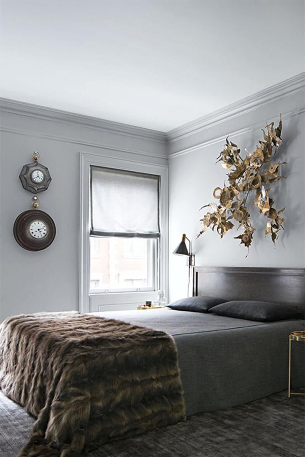 Relaxing neutrals in a stylish bedroom with grey-painted walls.