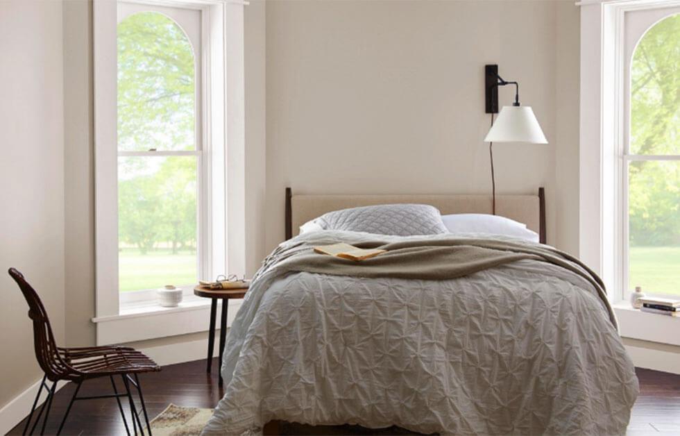  A bedroom with off-white painted walls and soft neutral tones.