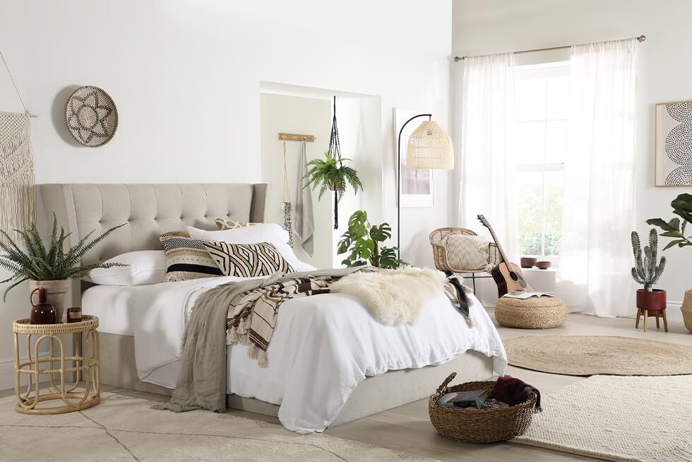 Oatmeal fabric bed in a comfortable neutral modern boho bedroom