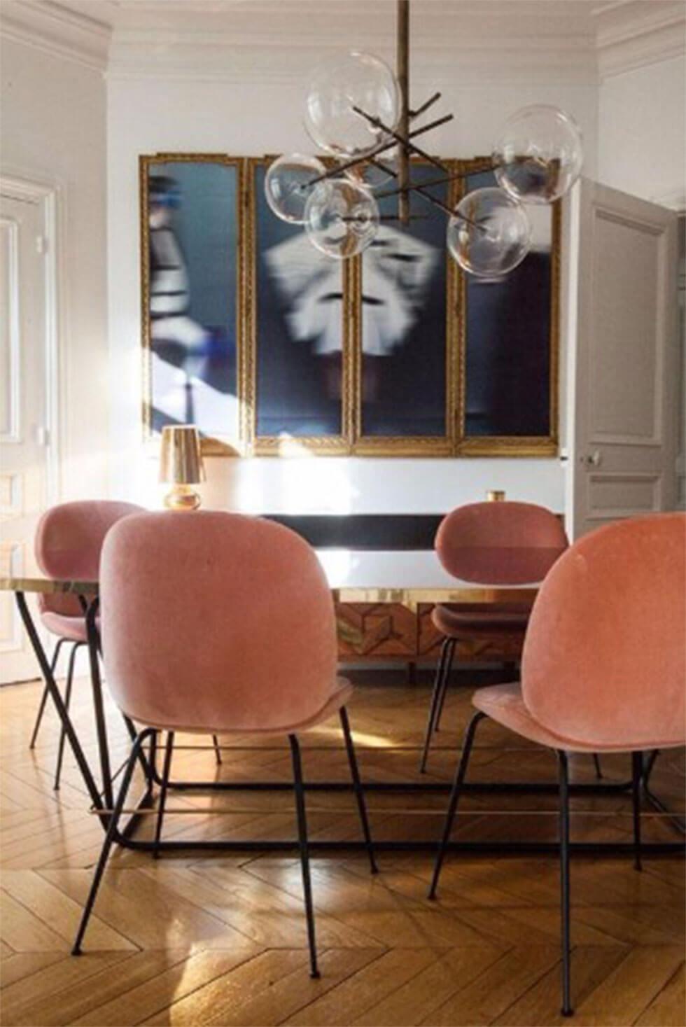 Modern dining room with pink Art Deco-inspired chairs