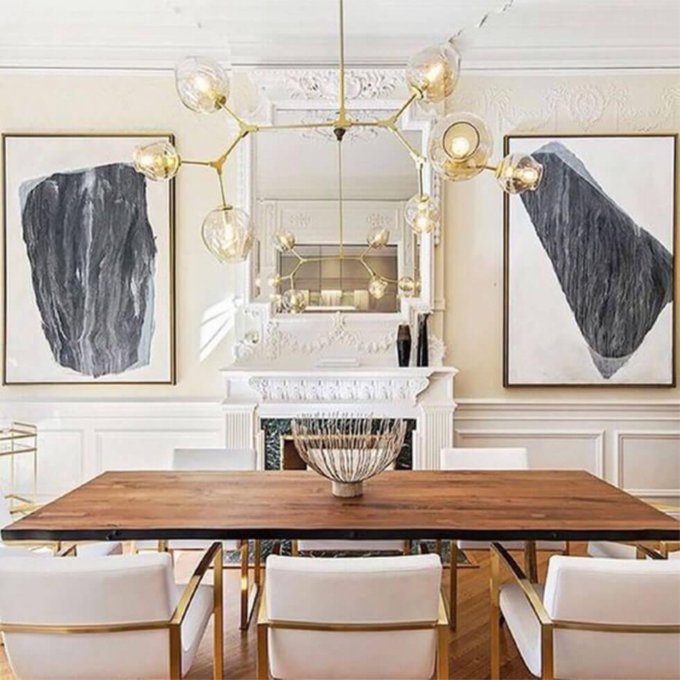 Modern dining room with wooden table and fabric chairs with gold accents