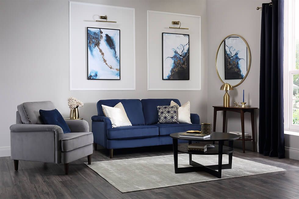 Elegant blue and grey living room with gold and black accessories