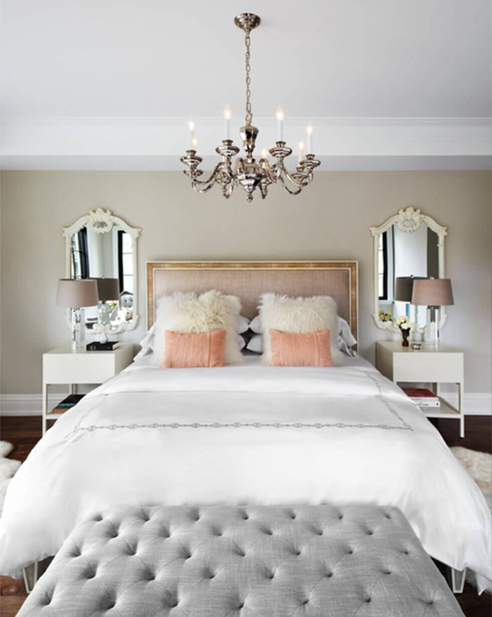 A Parisian chic bedroom with feature bedside mirrors