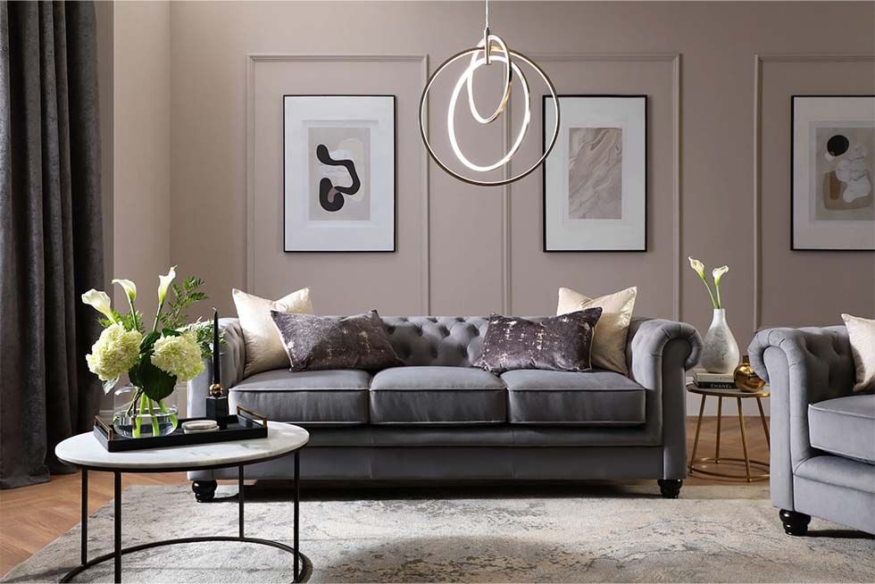 Grey velvet Chesterfield sofa in a chic and lux living room