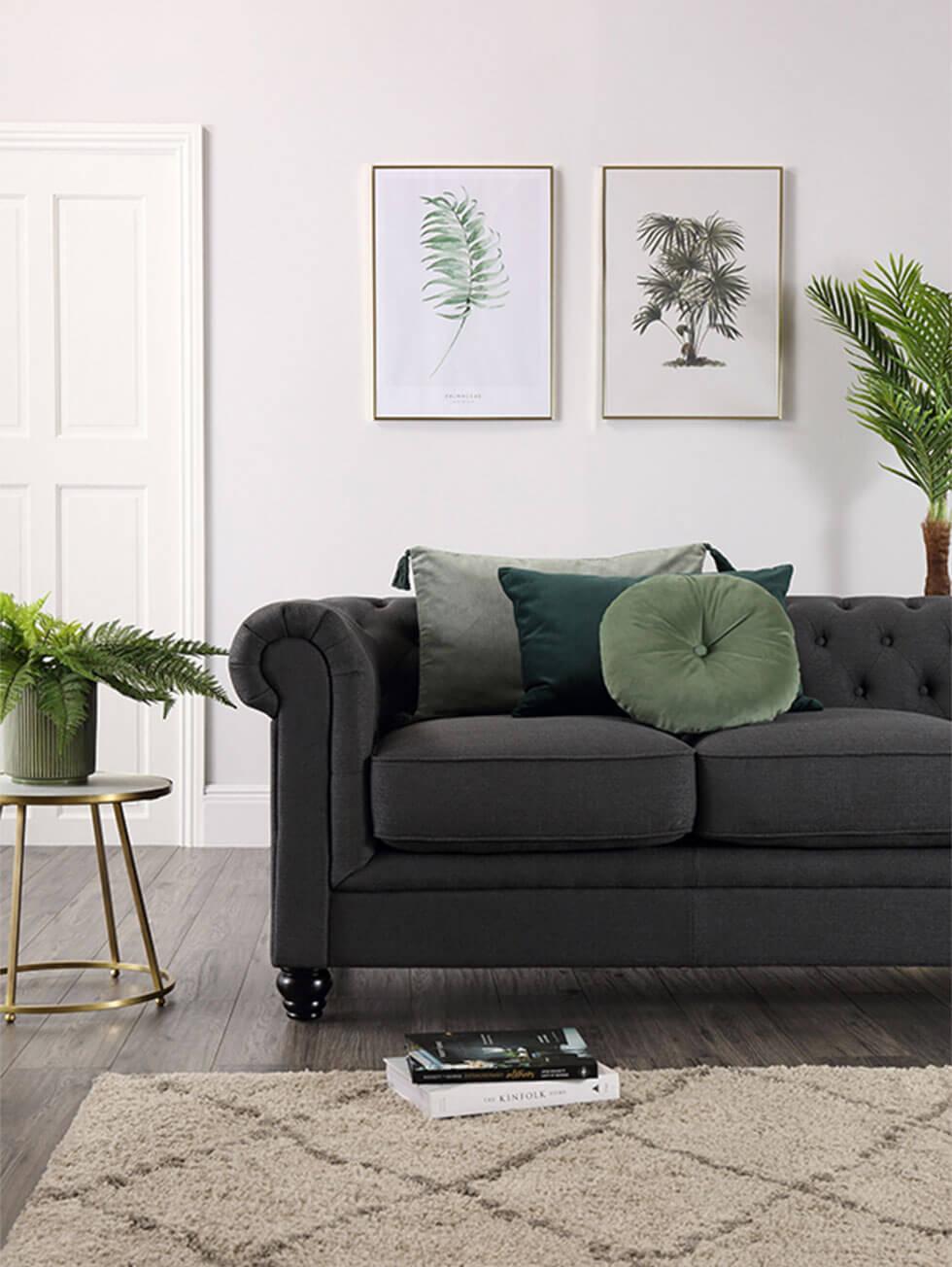 dark grey fabric sofa in a modern living room with plants