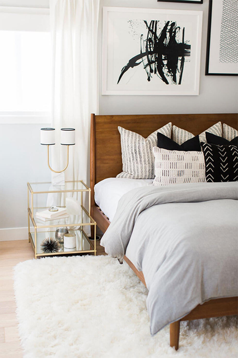 Wooden bed with many pillows for an extravagant feel