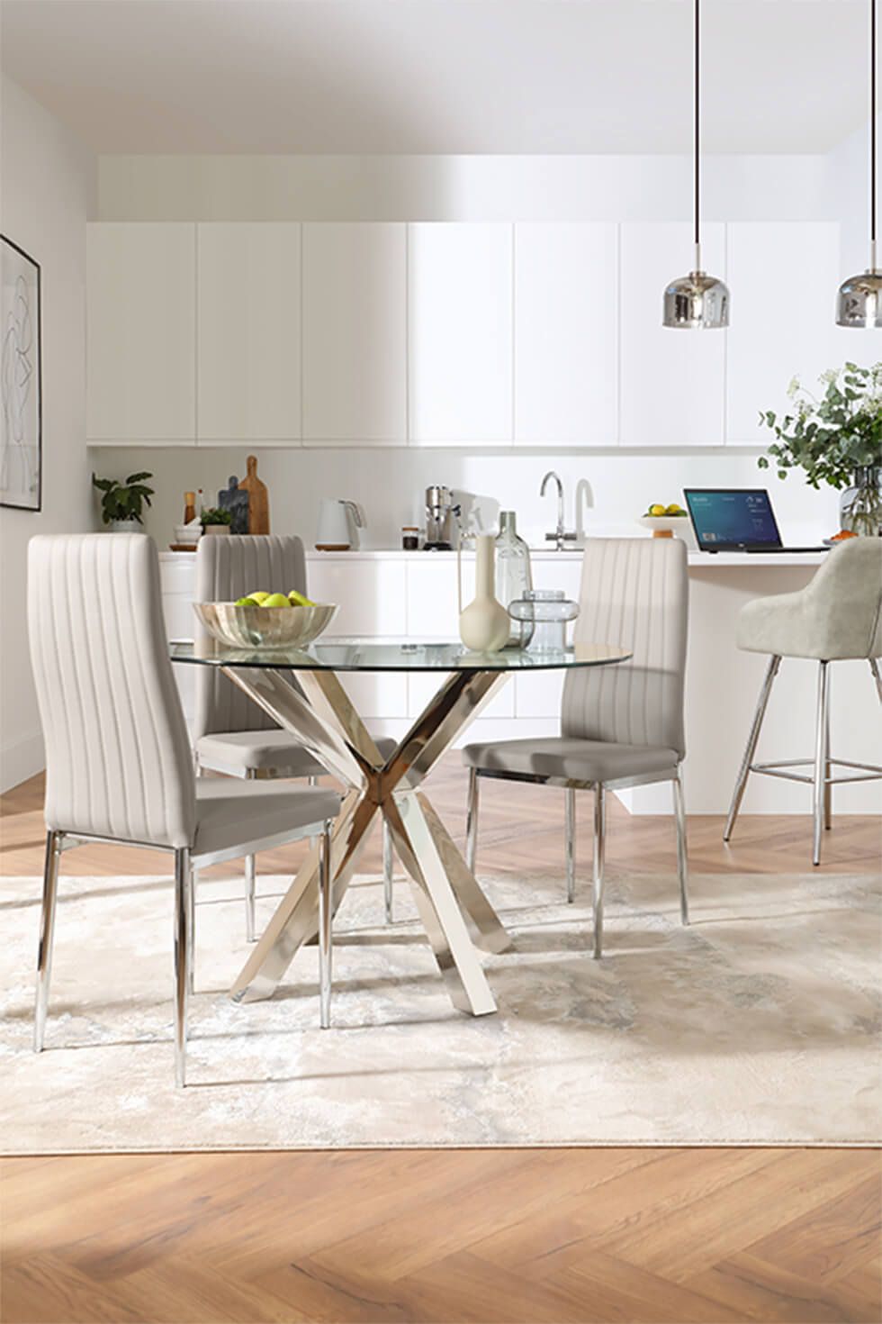 Modern neutral dining and kitchen area featuring a round dining table with chrome legs