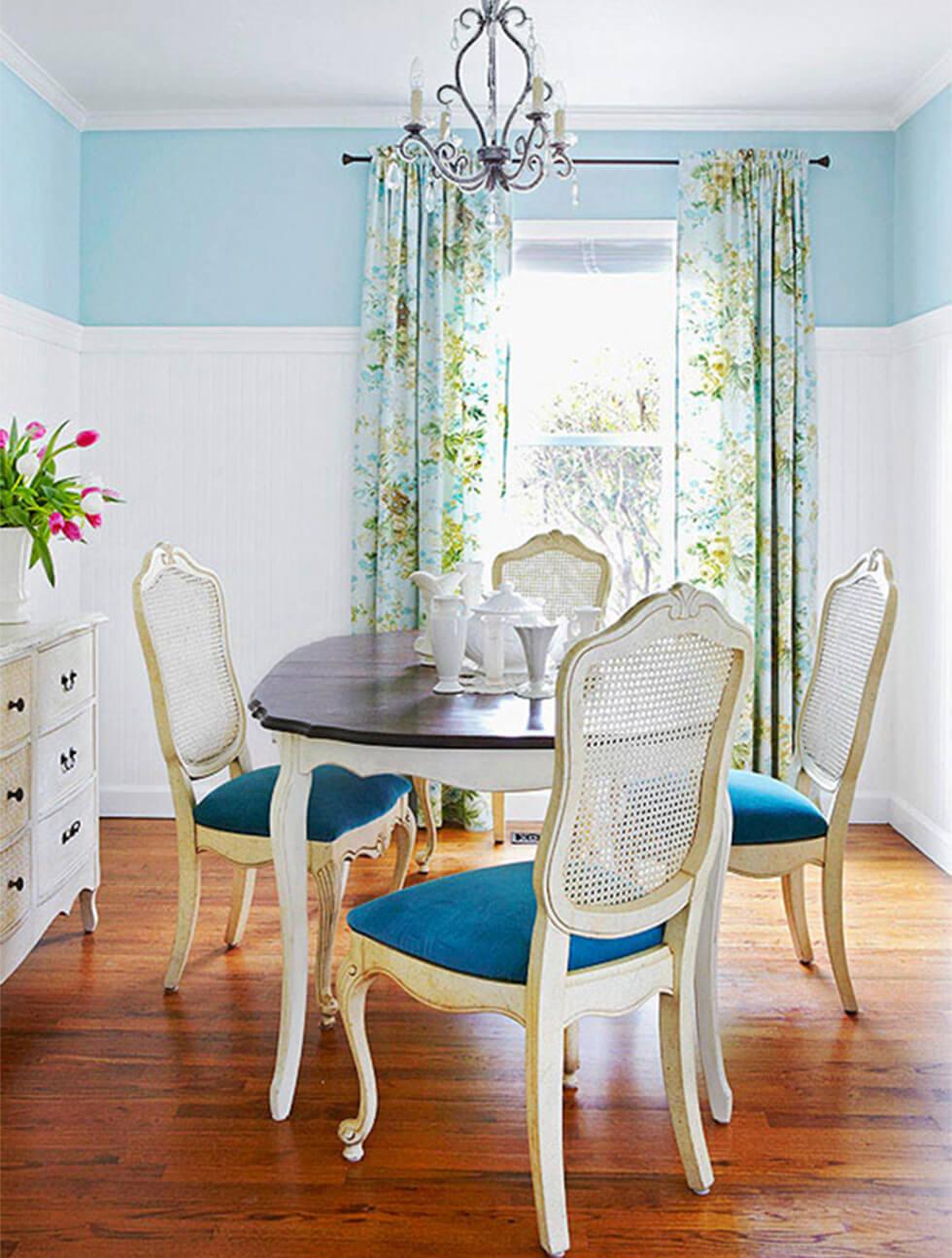 Two tone small dining room with white and blue walls, a classic dining set