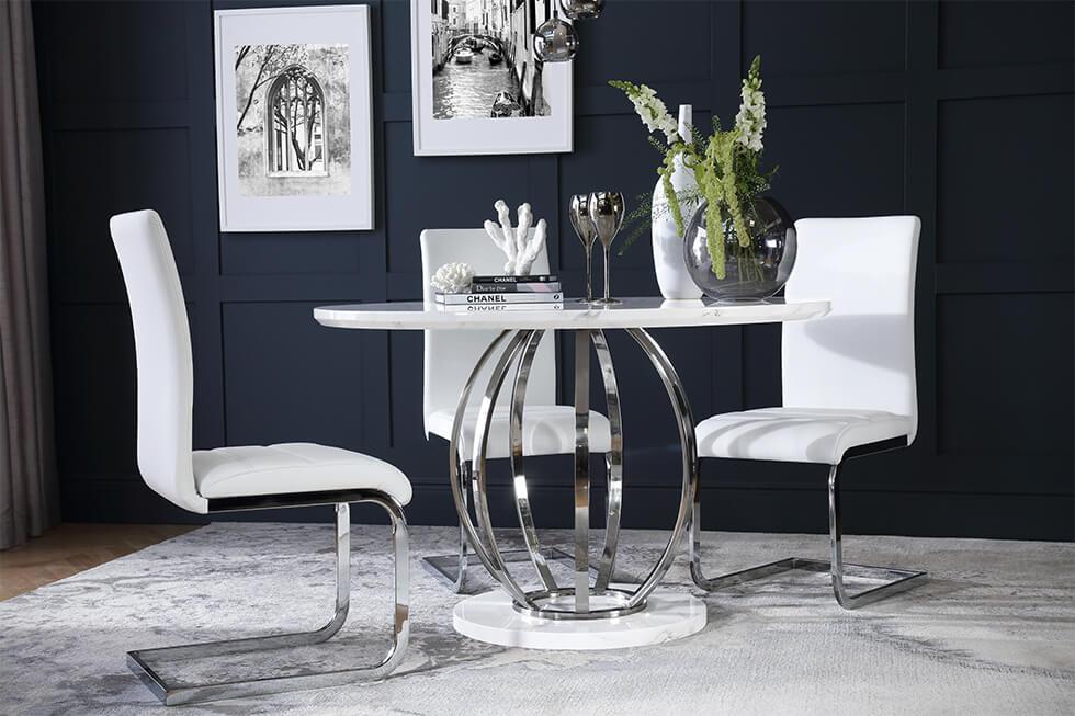 Small dining room with white marble and chrome dining table with white leather chairs against dark walls