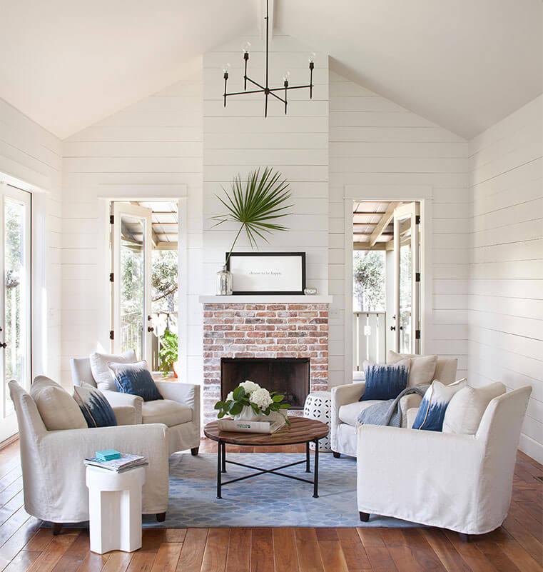 Cosy living room with armchairs facing a fireplace.