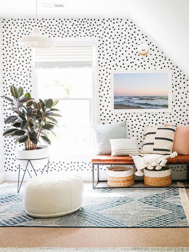 Spotted wall design in a cosy living room with tassels on cushions.