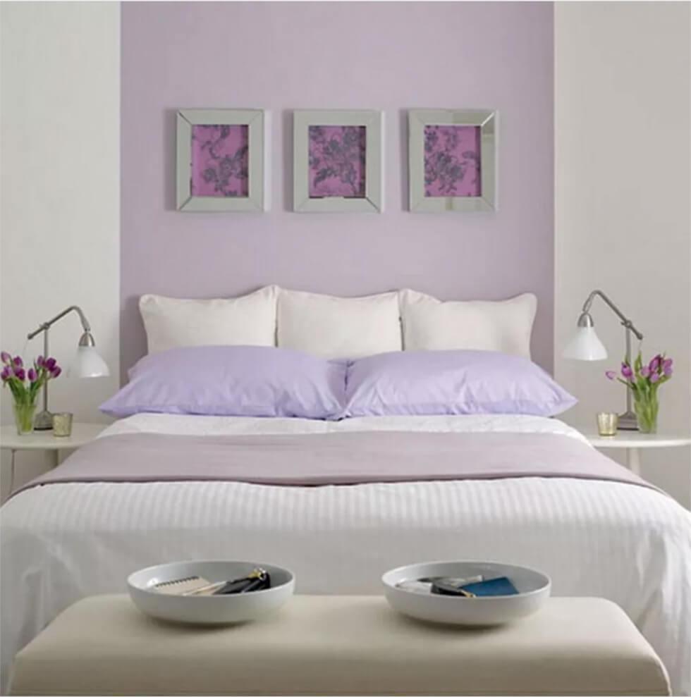 Bedroom with lavender purple feature wall and classic white bed