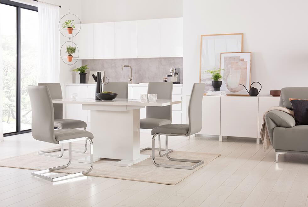 Modern high gloss dining room with a pedestal table, beige cantilever chairs and built in storage