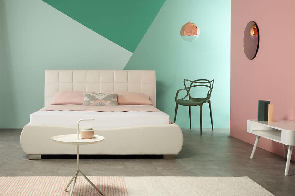 Contrasting colour block bedroom walls in neo-mint green and blush pink.