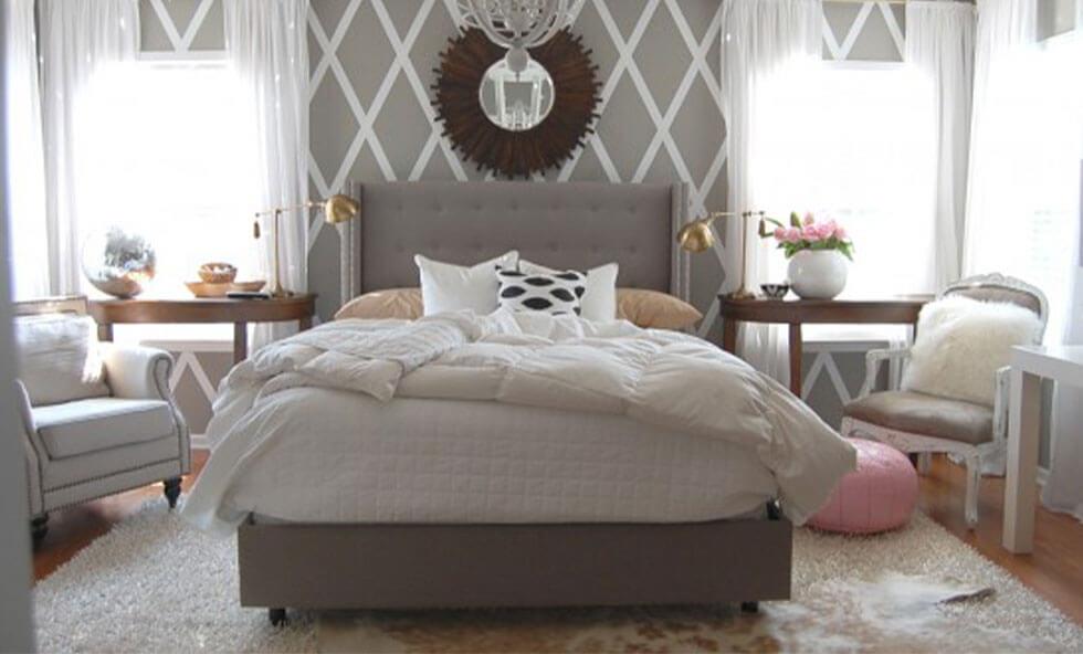 A grey bedroom with a geometric diamond wall.