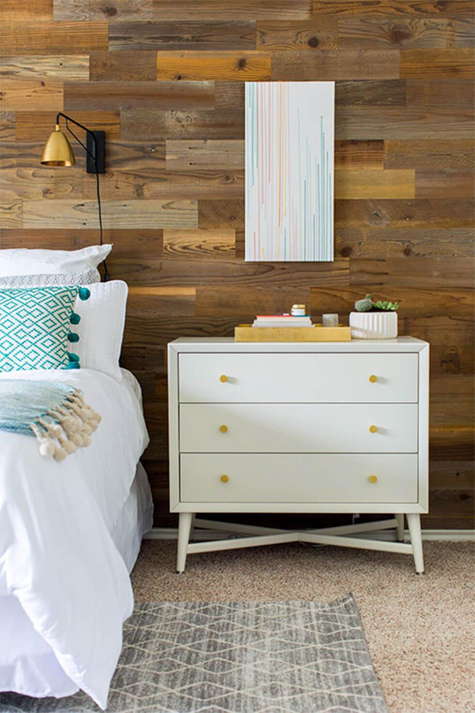 A rustic styled bedroom with a wooden feature wall.