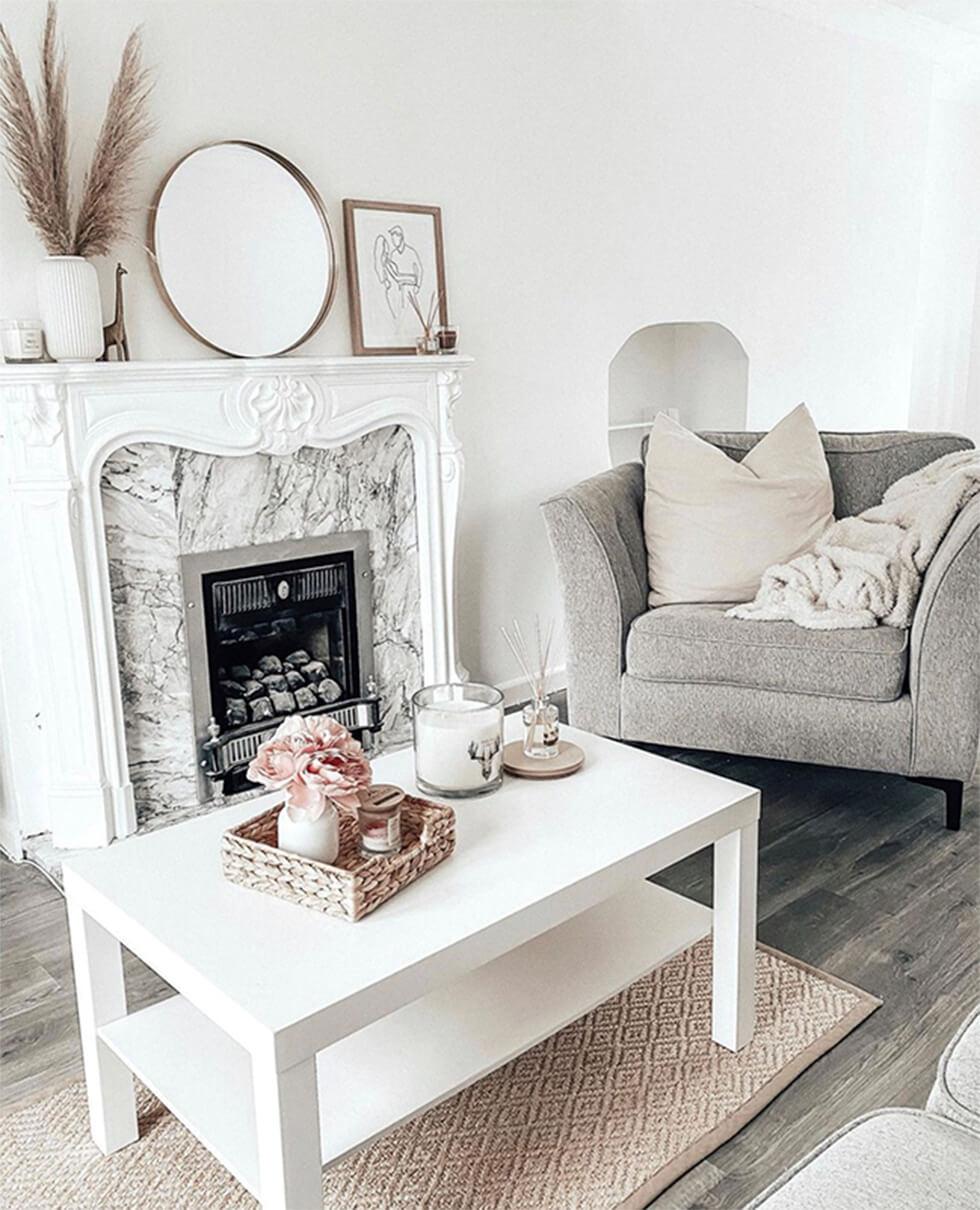 Stylish neutral living rooms with framed pictures on mantelpiece