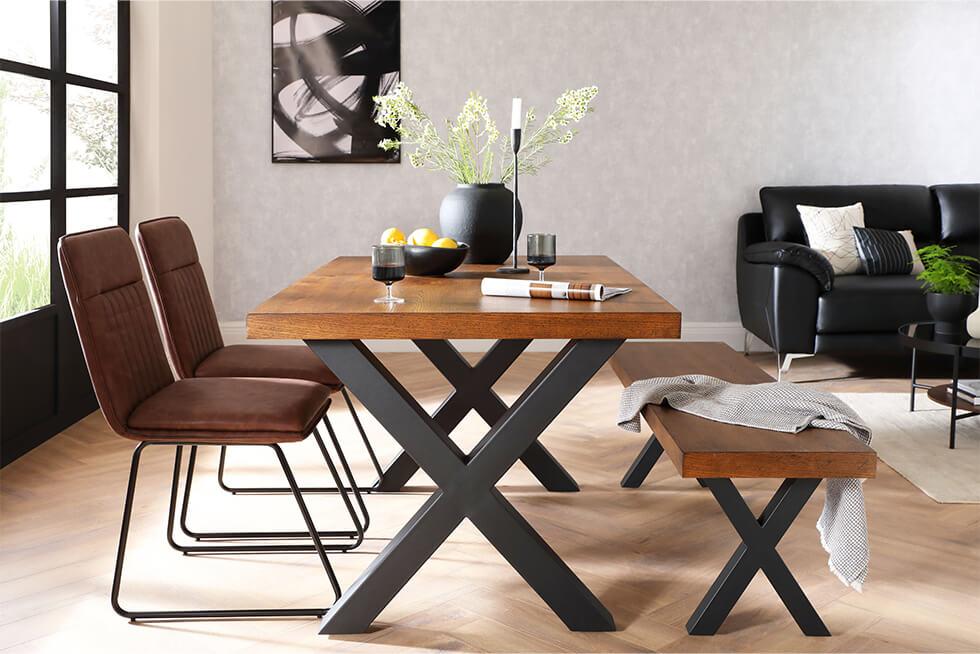 Industrial dining set in an open plan space with a concrete effect wallpaper