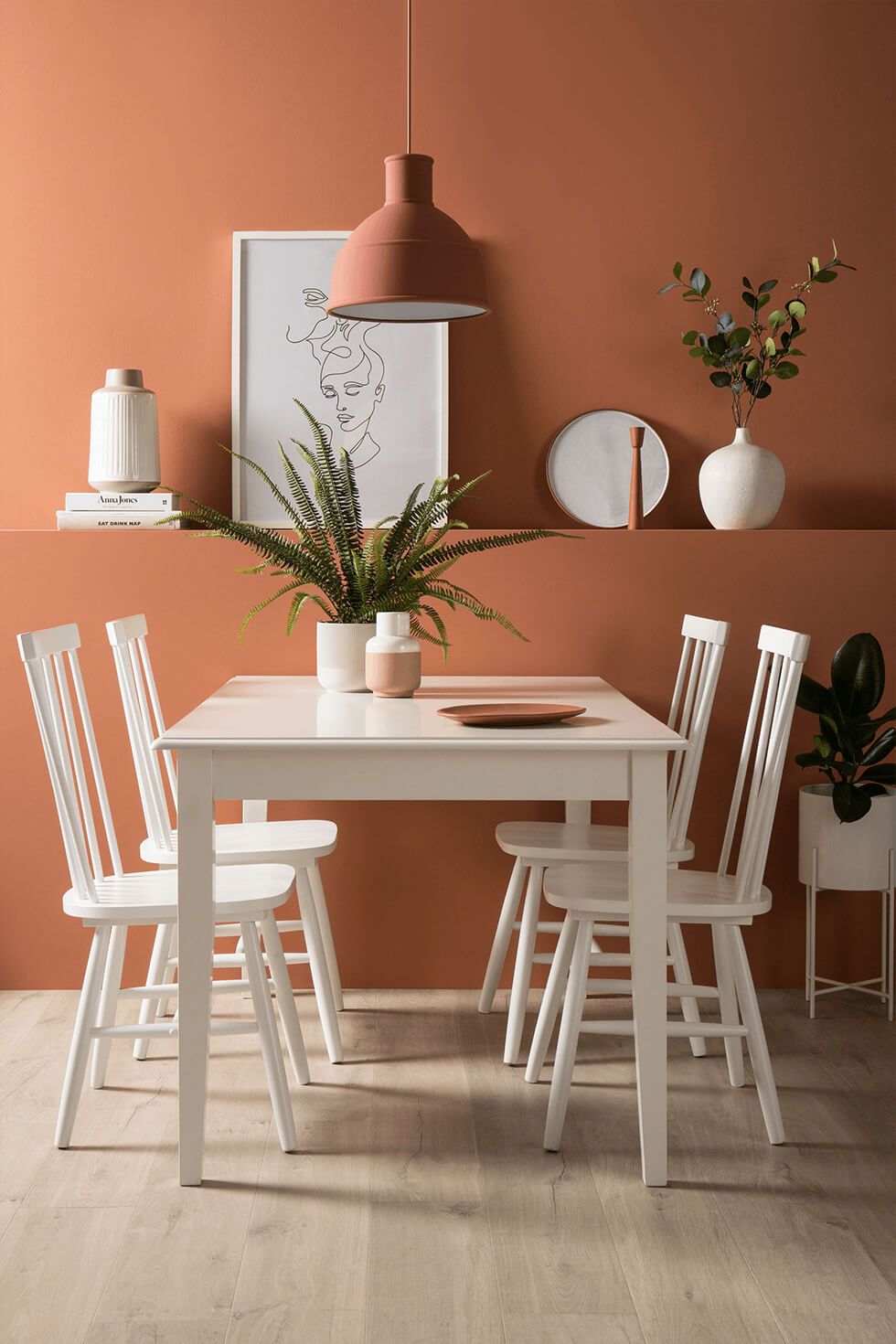 Burnt orange dining room with white dining set