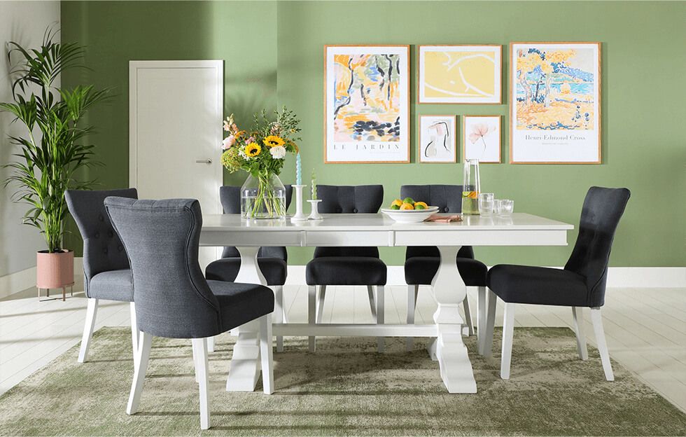 Dining room with white dining set and fresh green walls