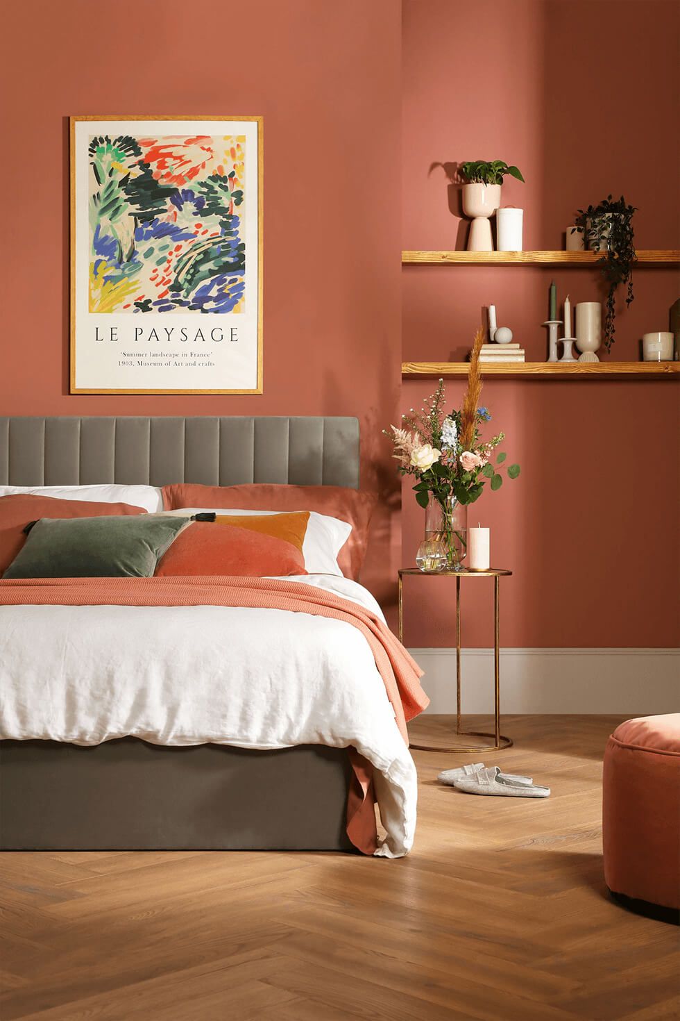 Bedroom with reddish brown walls and grey velvet bed