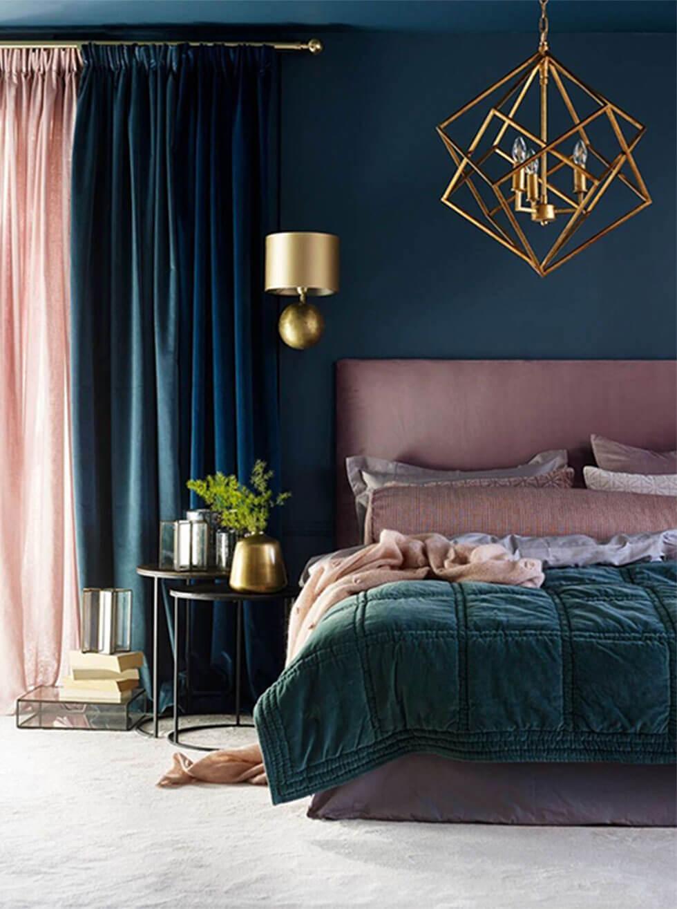 A dark teal green bedroom with dusky pink accents.