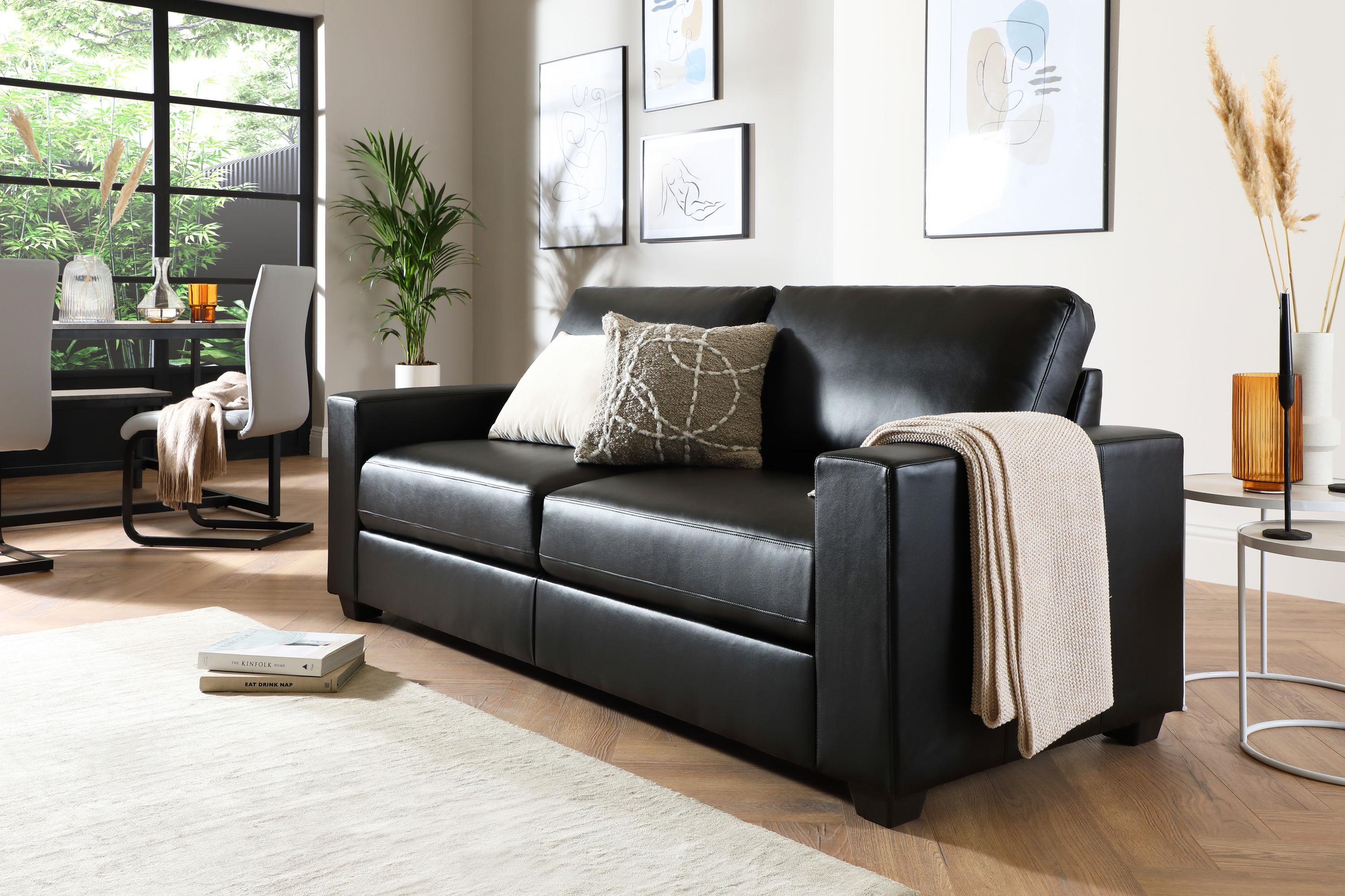 minimalist living room with black leather sofa