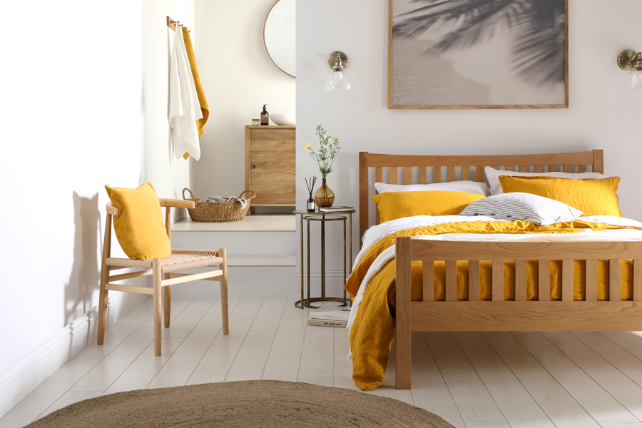 Mustard yellow accents in a neutral and natural bedroom