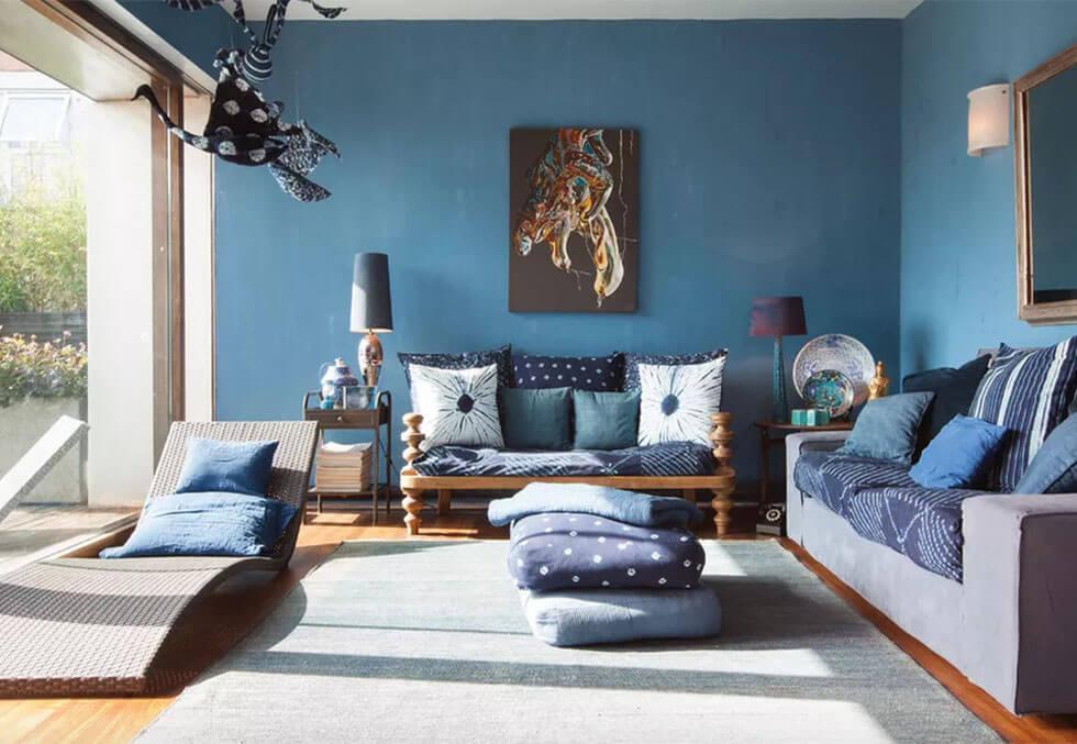 Blue bohemian living room with ikat fabric details.