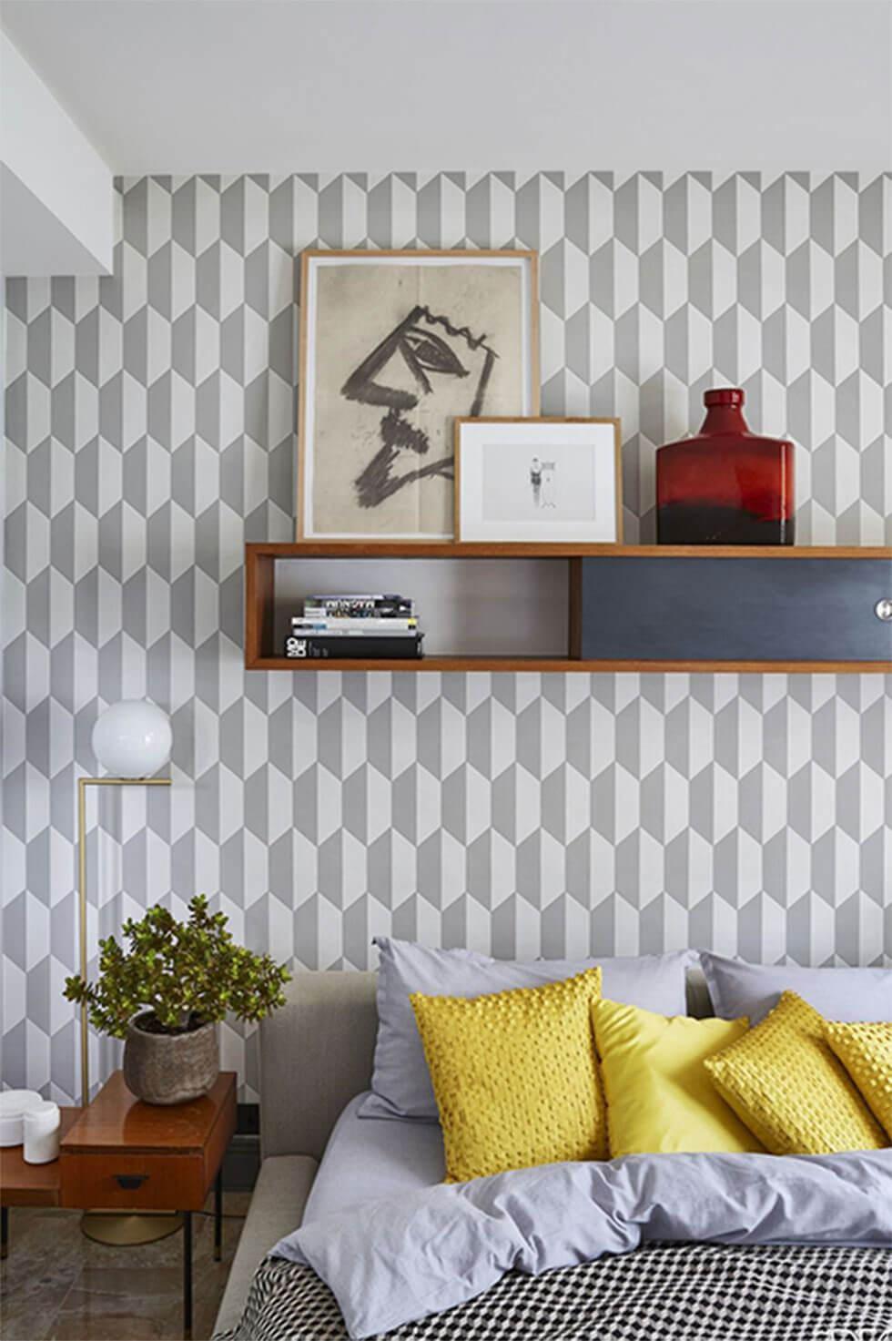 Bedroom with a grey patterned wall.