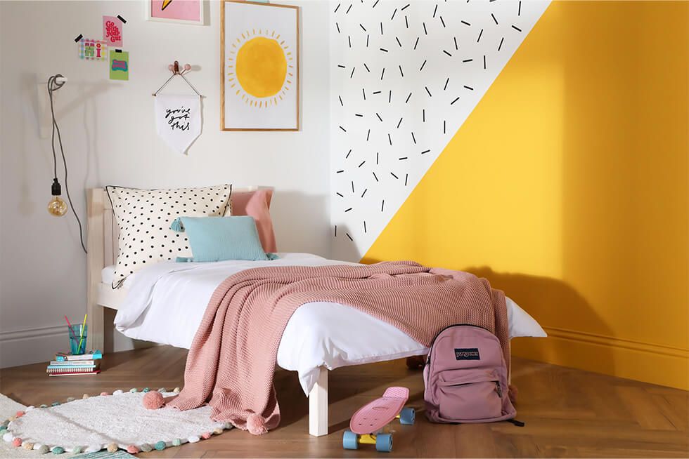 A child's bedroom in summer with geometric colour block walls