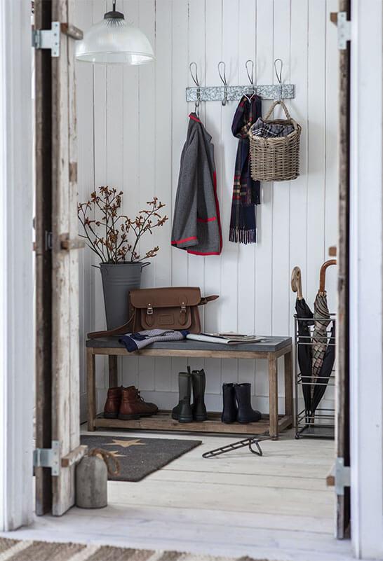 hallway closet with a coat, scarf, umbrellas and boots.