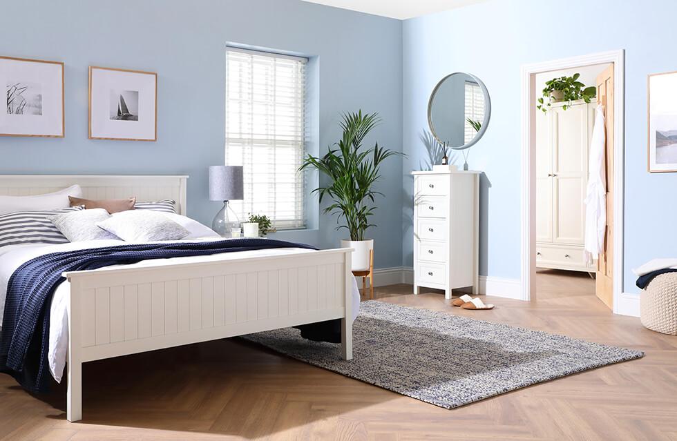 calming light blue bedroom with a white wooden bed