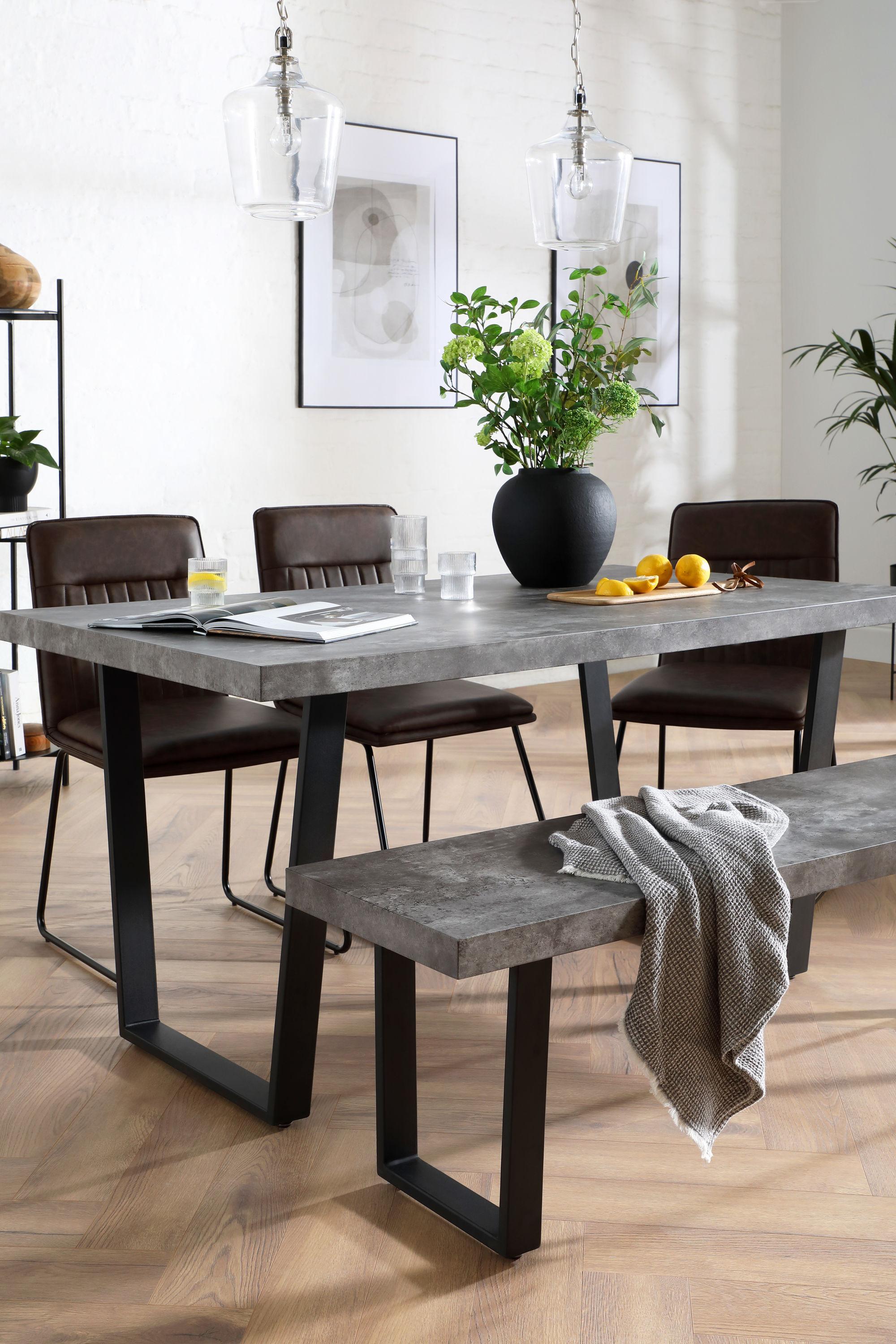 Industrial dining set with concrete table and leather chairs