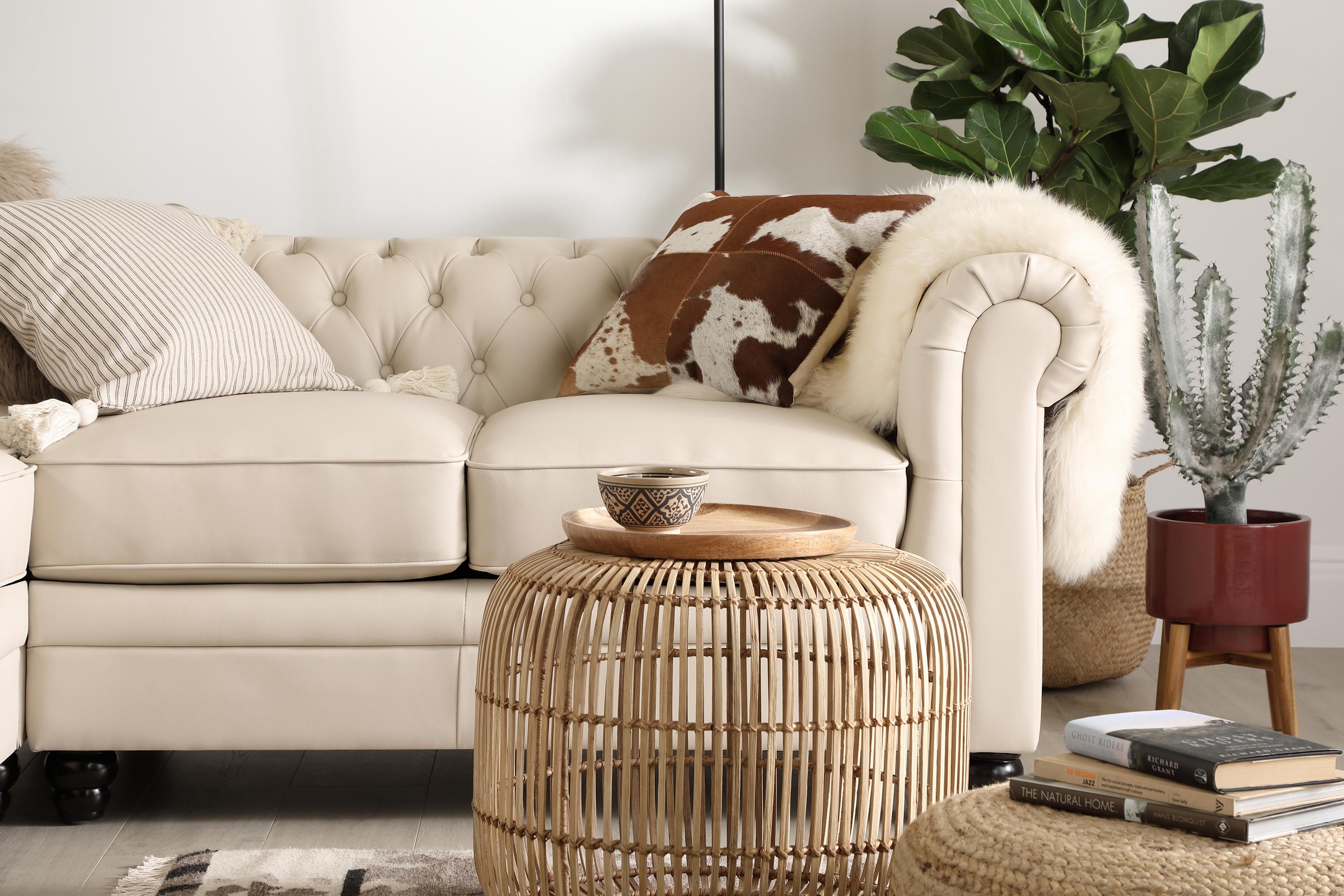 White leather sofa with natural decor and indoor plants