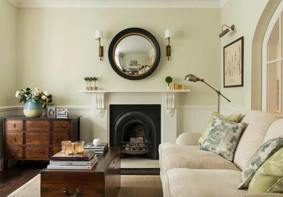 Light sage living room with cream sofa and dark wood furniture