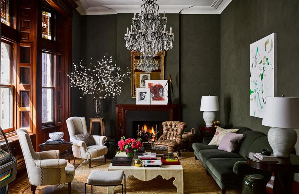 Classic living room with dark khaki walls and sofa, chandelier and white accents