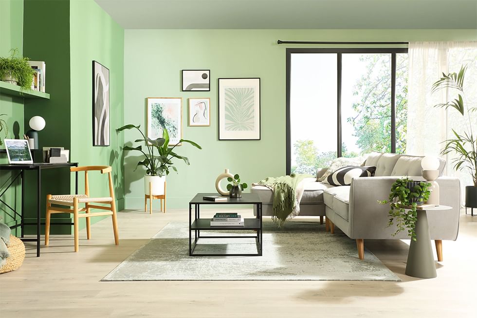 Green living room with grey sofa and work from home area