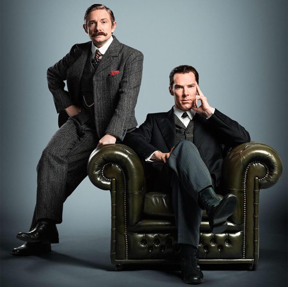 Sherlock Holmes and Dr Watson on a leather Chesterfield armchair