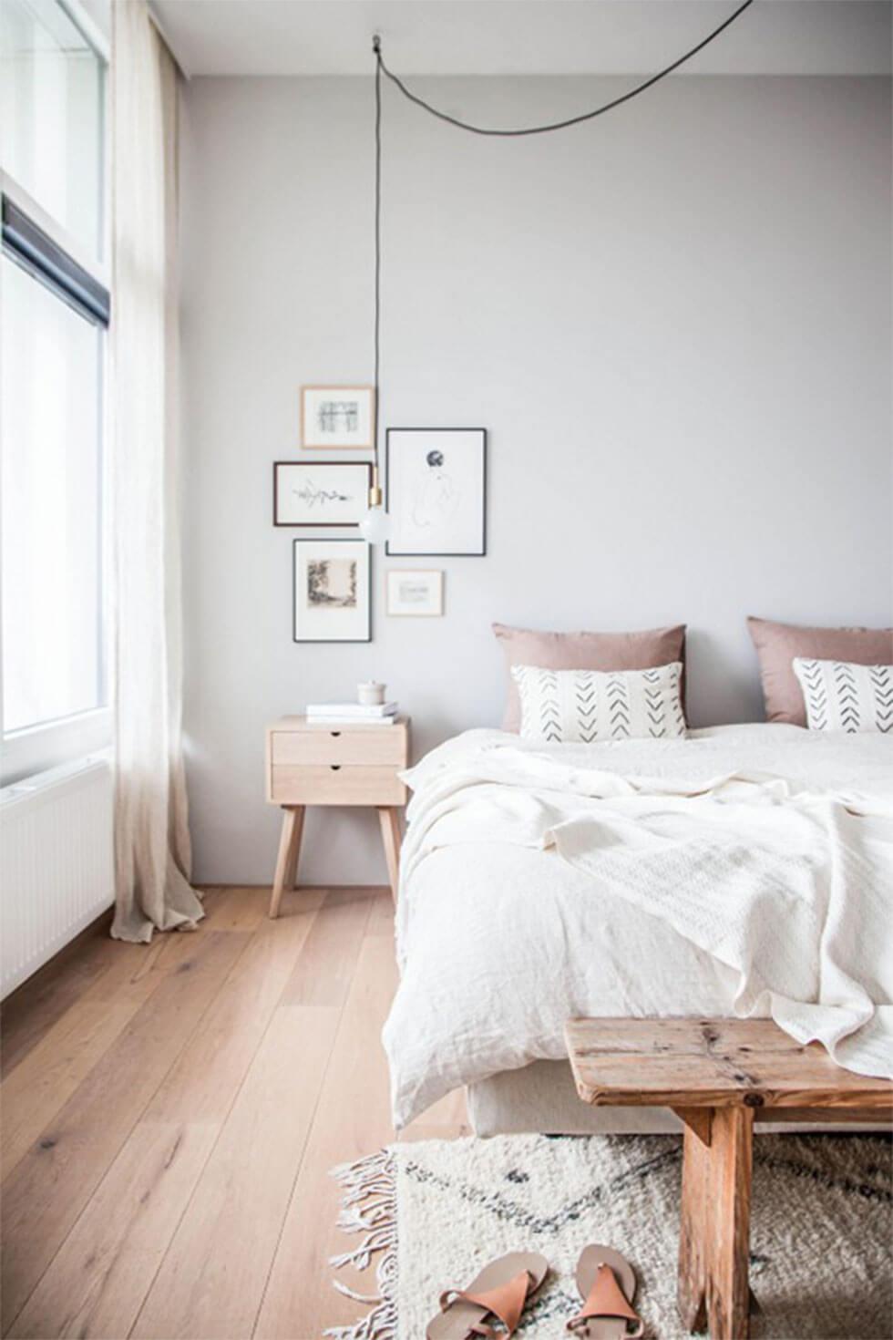 White bedroom in Scandinavian style with light wood furniture.
