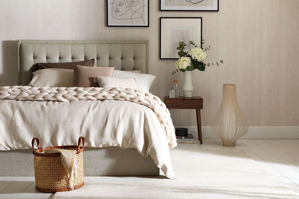 Mid-century bedroom with a coral headboard and patterned quilt