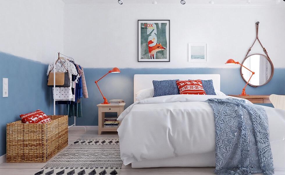 A modern and cosy bedroom with half-painted colour blocked walls in blue and white