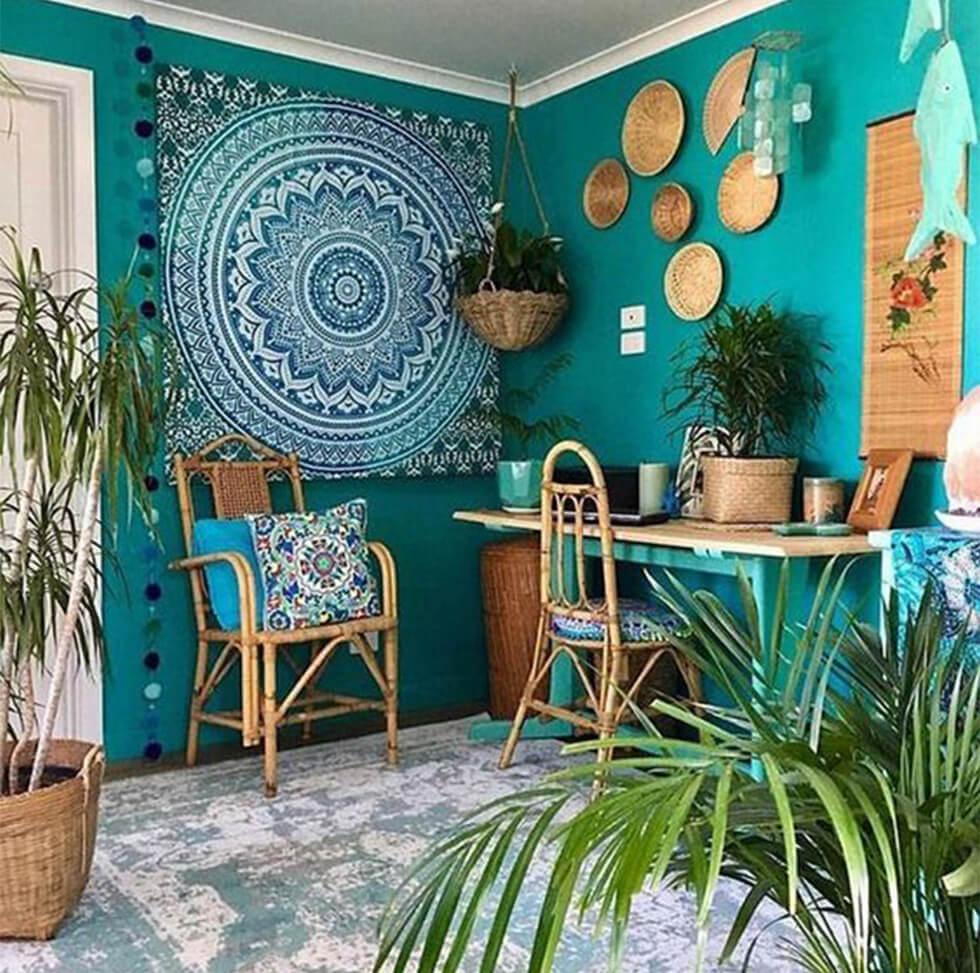 Bohemian bedroom with turquoise wall, rattan accessories and colourful wall hangings