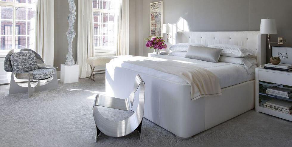 Neutral grey bedroom with statement silver chairs