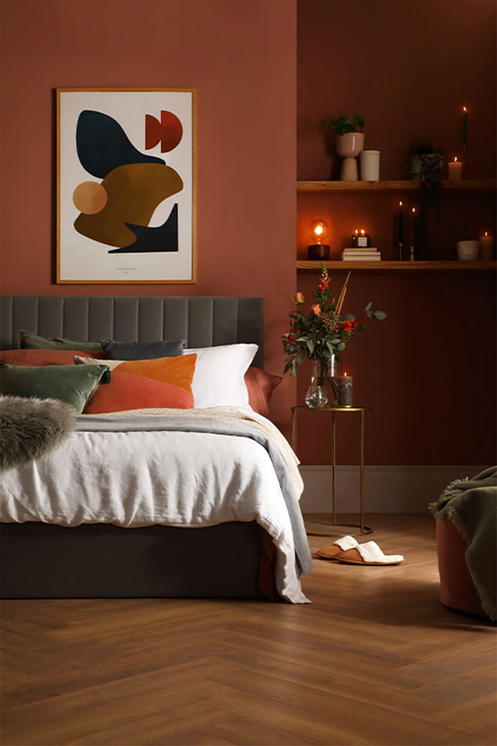 Cosy bedroom with red walls and velvet bed