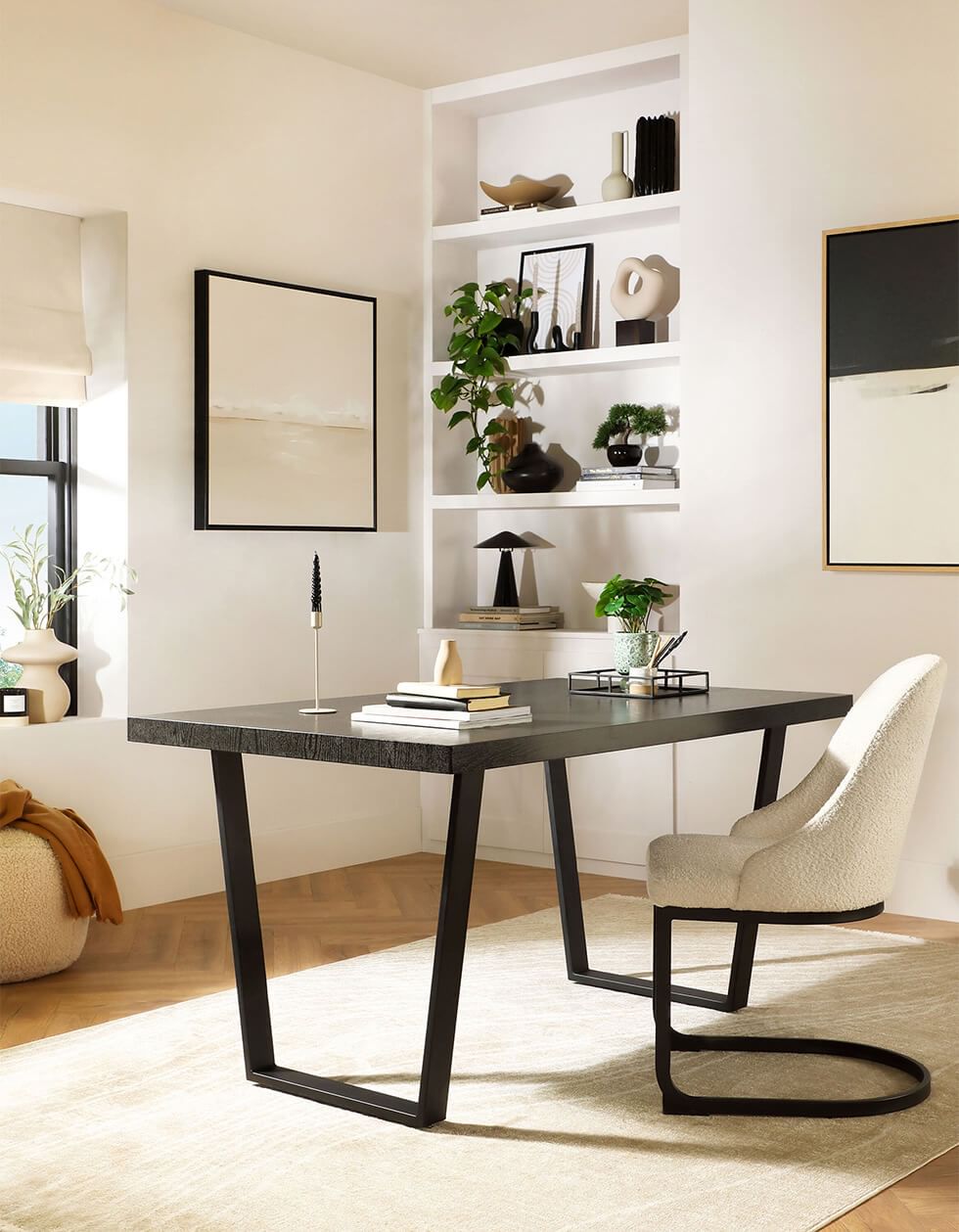 Home office with a modern table and boucle chair