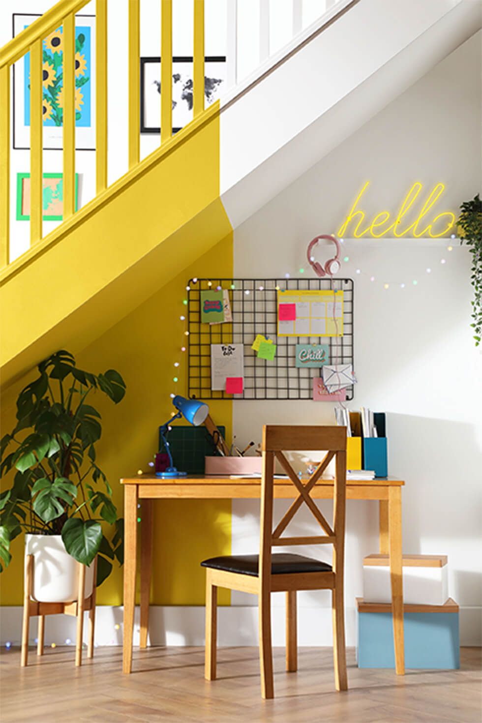 Bright yellow accents at an under stairs desk nook