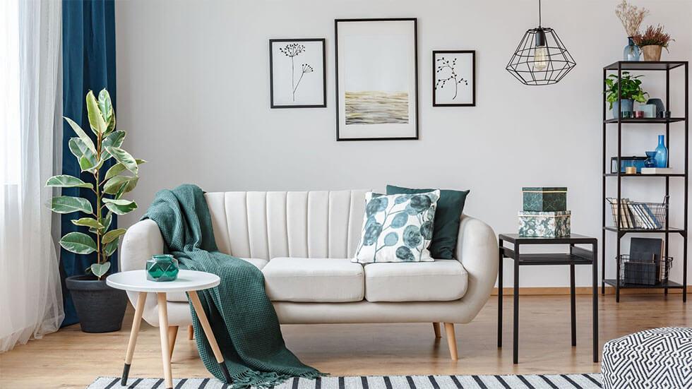 Green throw and pillows on a white sofa in the living room